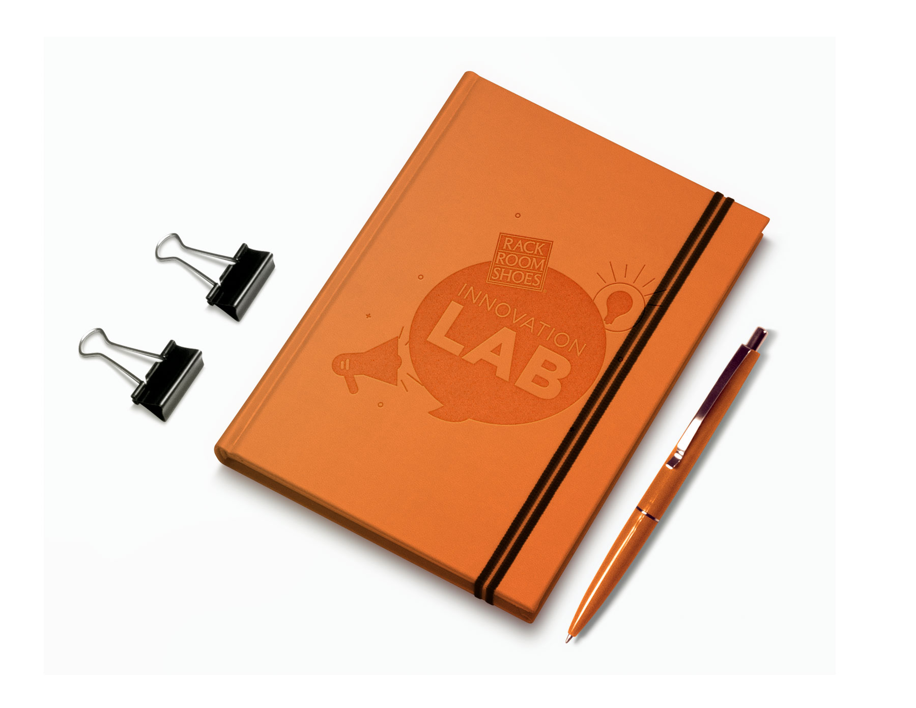 a small orange notebook with the innovation lab logo engraved into it