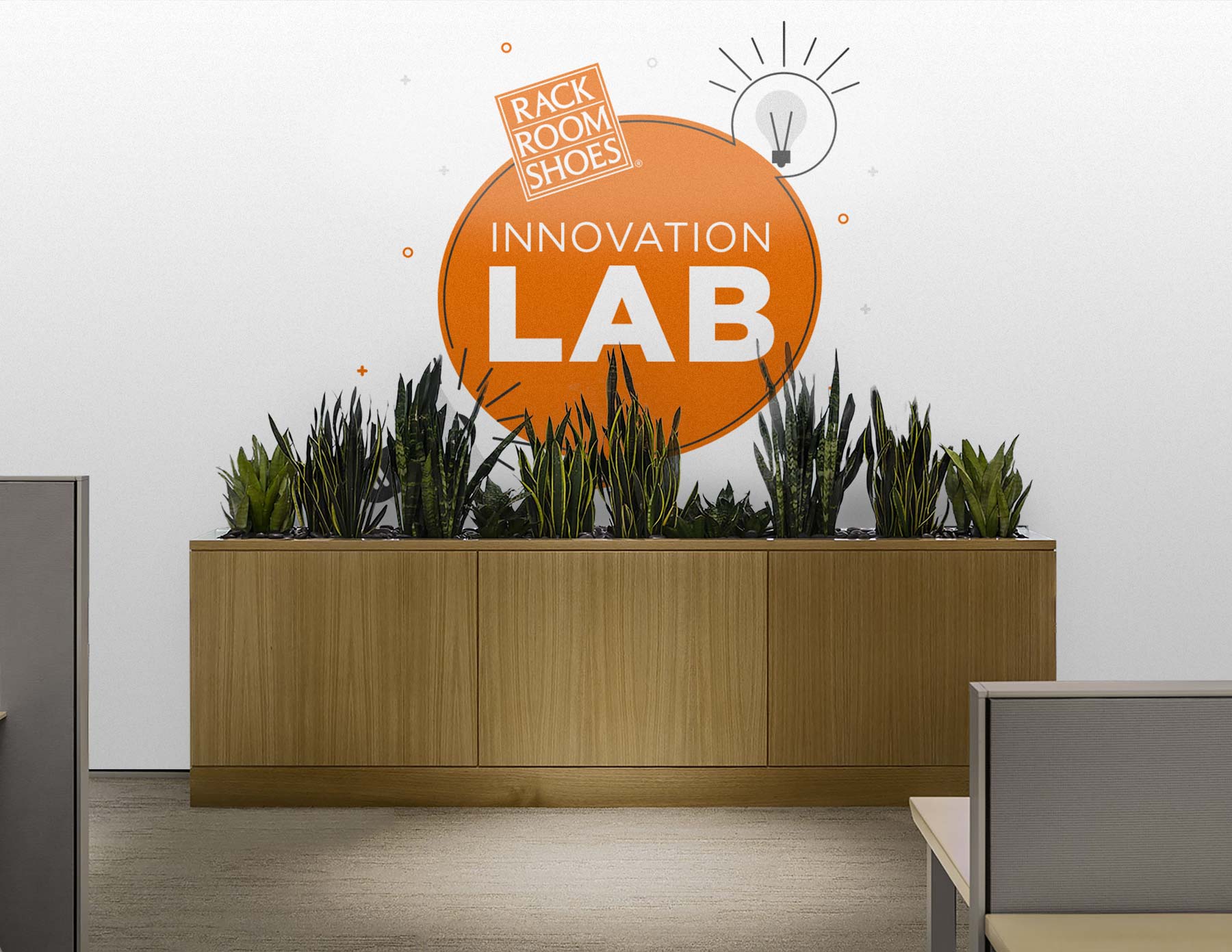 the innovation lab logo painted large on a wall with an office planet in front of it