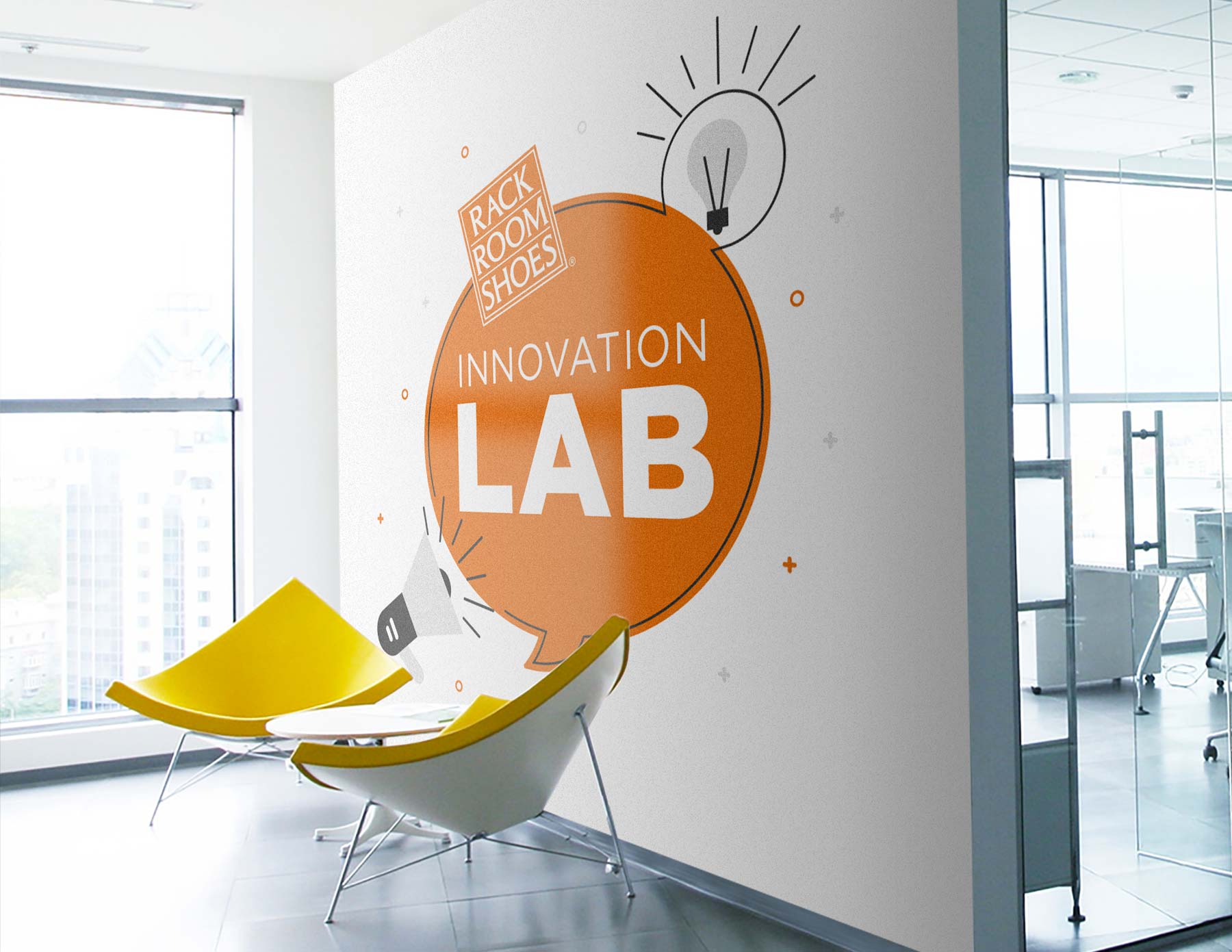 a very modern office setting with the innovation lab logo painted on the wall